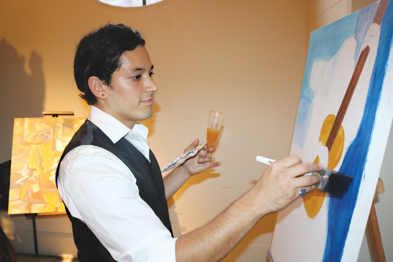 “Pablo Picasso” paints for his fans at the charity event.